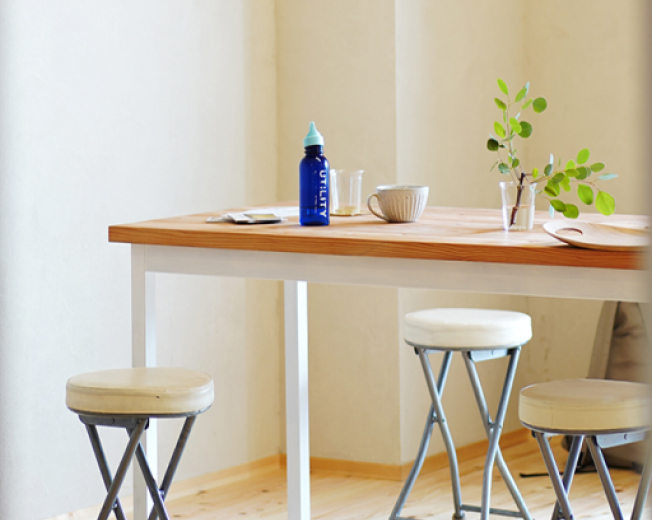 明るい室内にある木のテーブルと椅子の写真。穏やかな雰囲気のワークスペース
